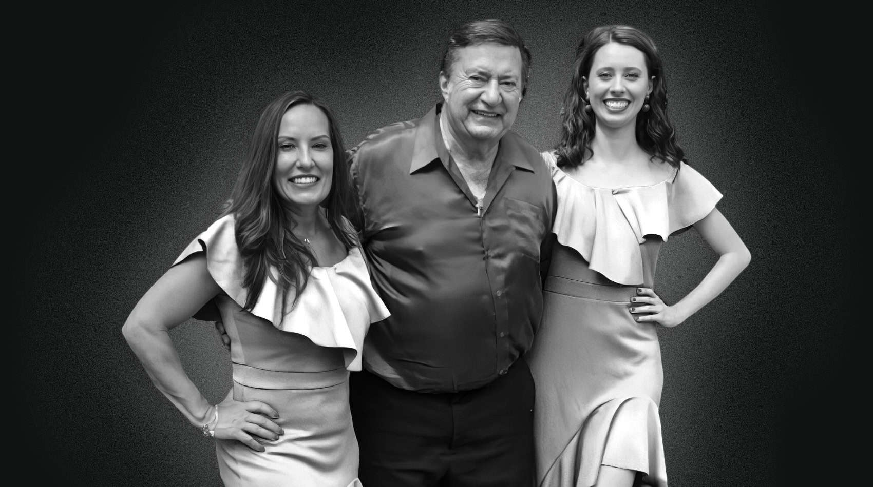 Black-and-white photo of Joe Martino with two performers in ruffled dresses
